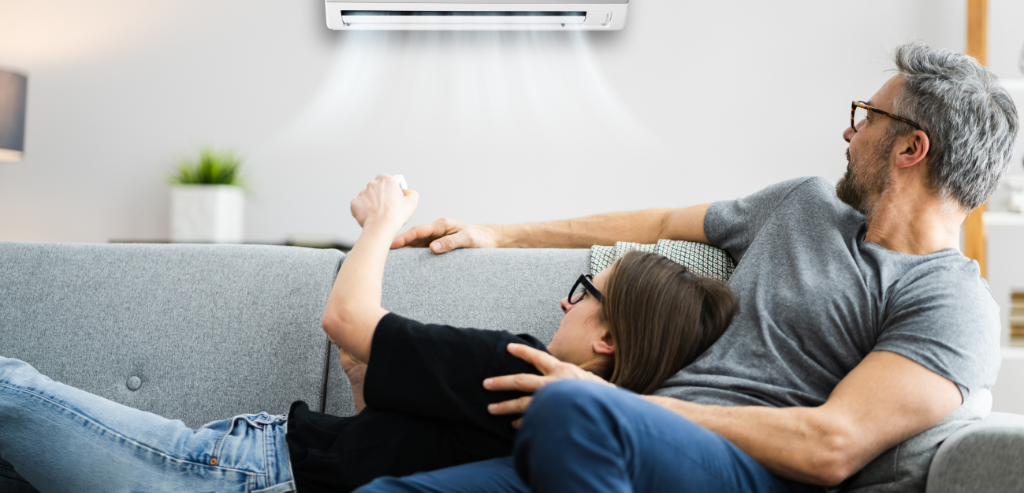Family relaxing comfortably in a living room with air conditioning