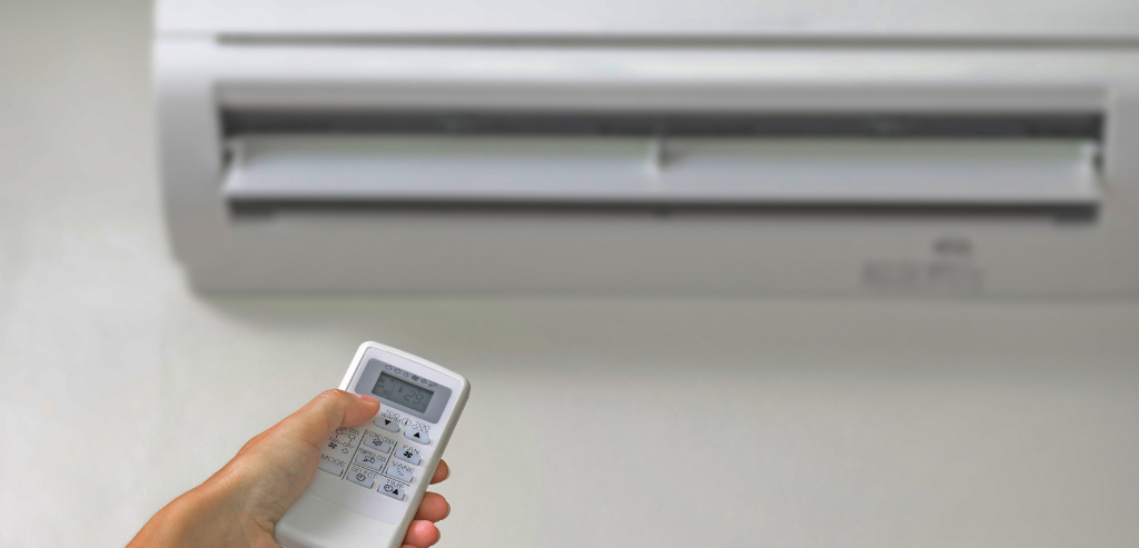 Wall-mounted split system air conditioner being operated with a remote control